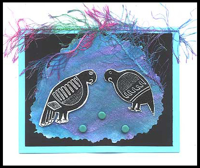 This card was created using the Mimbreno Parrots, brads and colorful yarn.